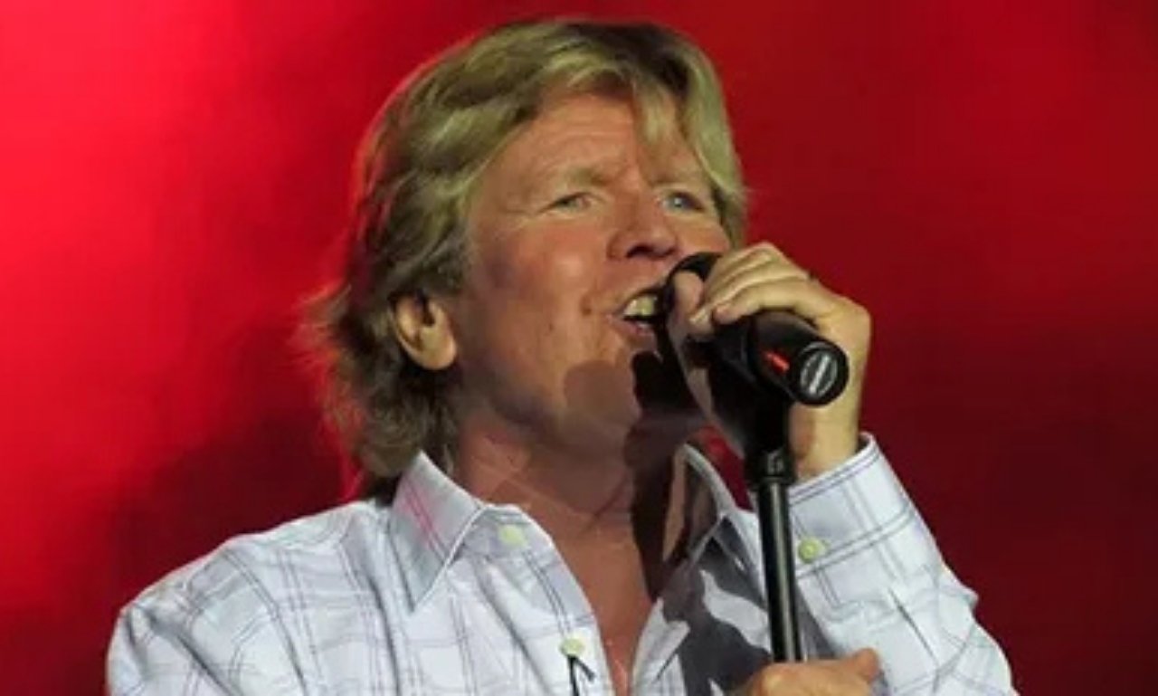 Peter Noone performing on stage during his legendary music career.